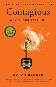 Cover of "Contagious" by Jonah Berger with a dandelion in a lightbulb base.